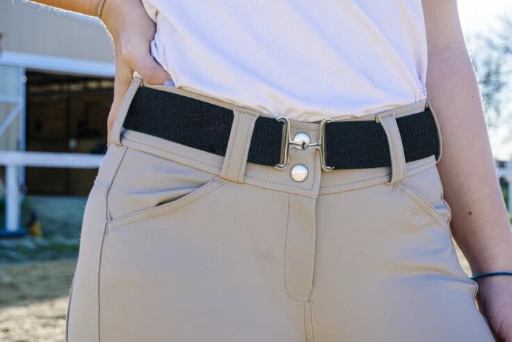 Stylish equestrian belt showcased with riding gear.