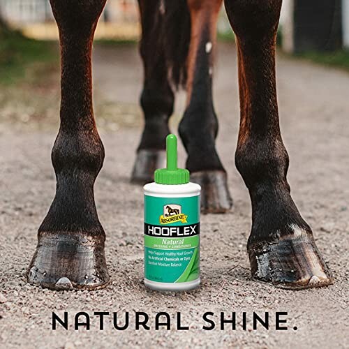 Horse hooves with Hooflex natural hoof conditioner bottle in front.