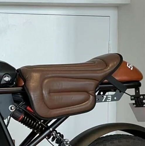 Close-up of a motorcycle seat with brown leather padding